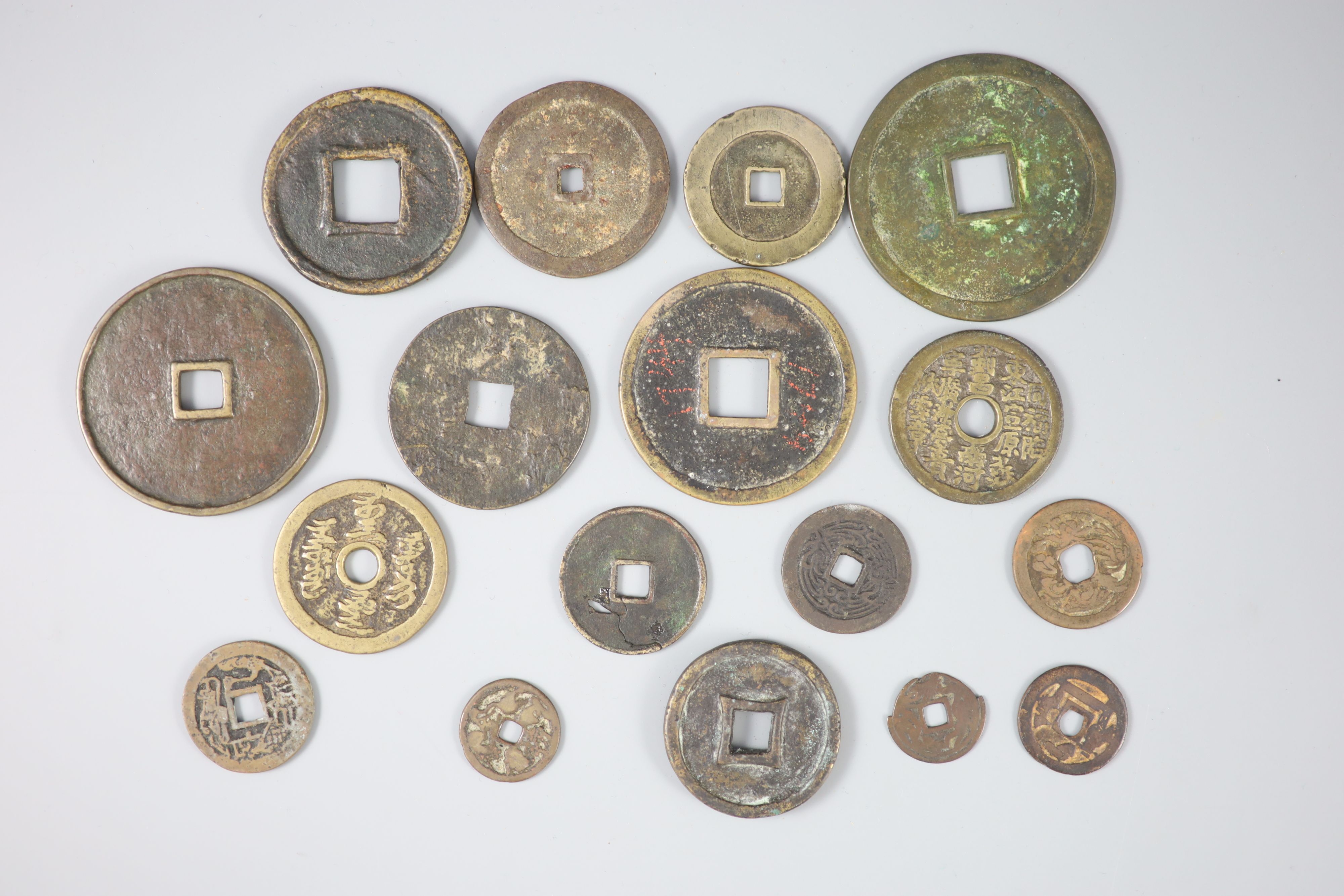 China, a group of 17 bronze or copper inscribed charms or amulets, Qing dynasty,